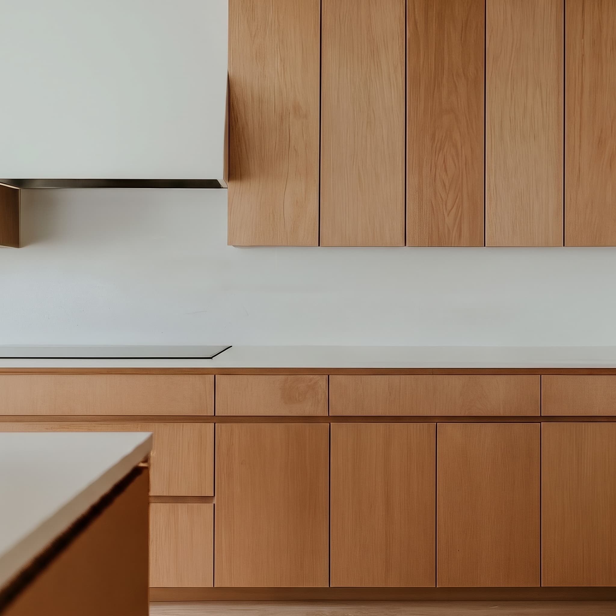 Warm oak kitchen with handleless timber cabinetry, a stone benchtop and a clean white splashback